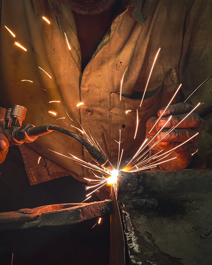 A dramatic photo capturing sparks from welding, highlighting industrial craftsmanship.